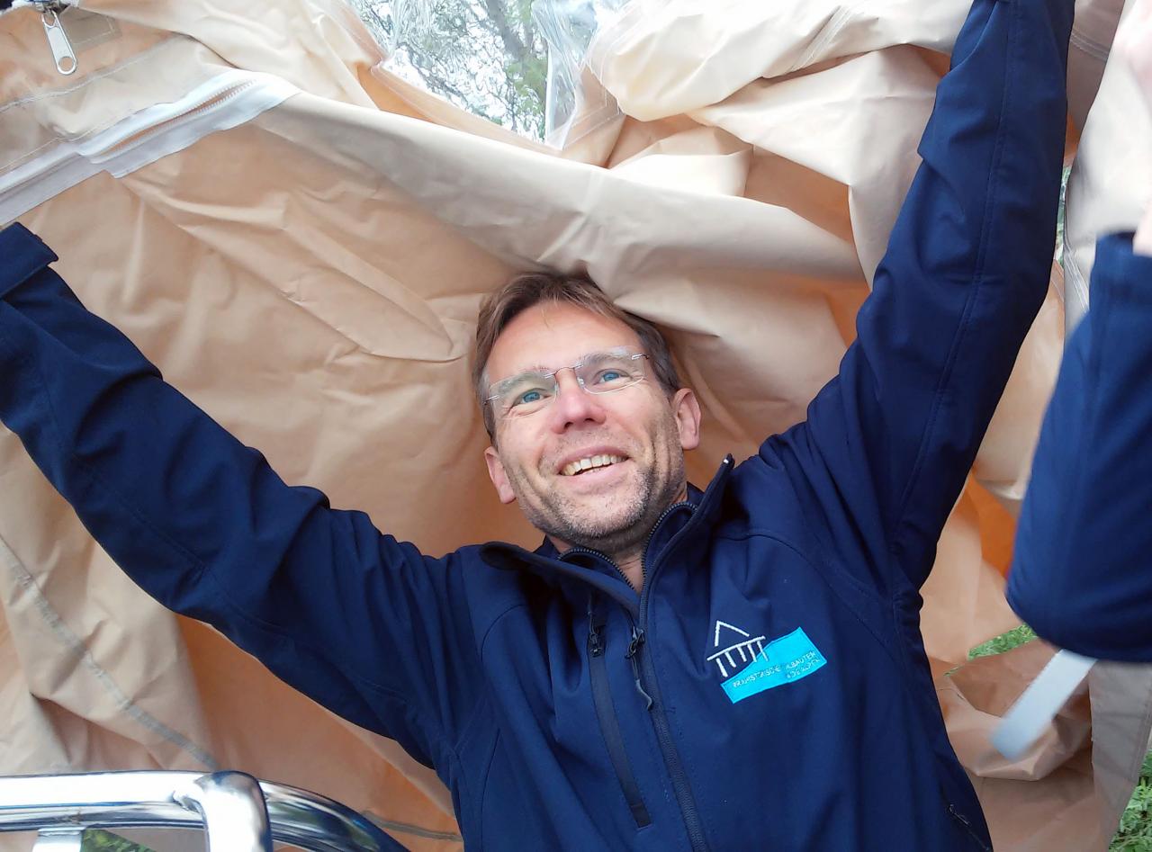 Henrik Pohl freudestrahlend beim Anheben der Bootsplane