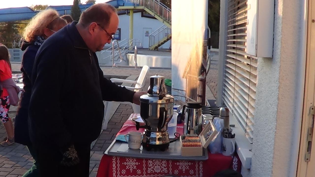 Ein Mann steht vor einem Tisch mit Kaffeemaschine 