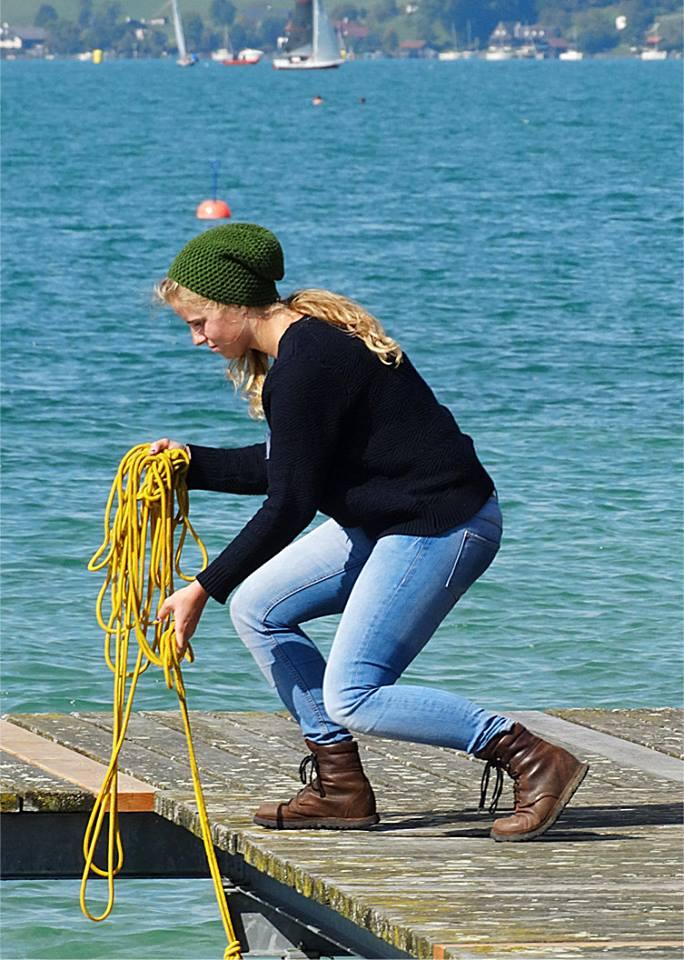 Sophie in gebückter Haltung am Steg mit einem Tau in der Hand